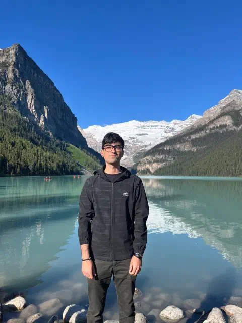 Apram at Lake Louise with mountains behind him